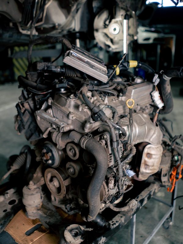 close up There is an elongated engine on the service station table ready for the car